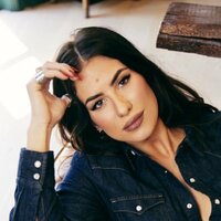 Image of Kassi Ashton linking to their artist page due to link from them being at the top of the main table on this page