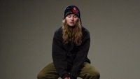 Image of girl in red linking to their artist page due to link from them being at the top of the main table on this page