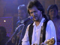 Thumbnail for the Travis Tritt - Here's a Quarter (Call Someone Who Cares) link, provided by host site