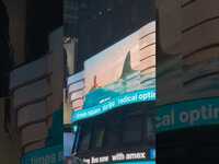 Thumbnail for the Dua Lipa - RADICAL OPTIMISM POP UP IN TIMES SQUARE 💙🌀 link, provided by host site